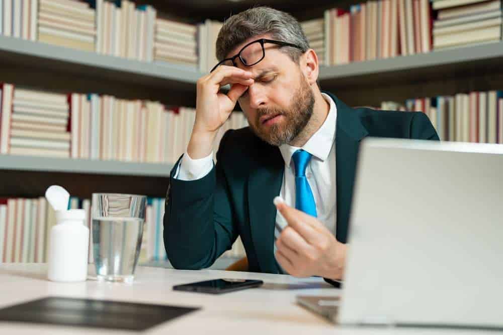 A distressed employee facing redundancy at his office desk, highlighting a $71,000 compensation outcome and the importance of redeployment obligations in Australia.